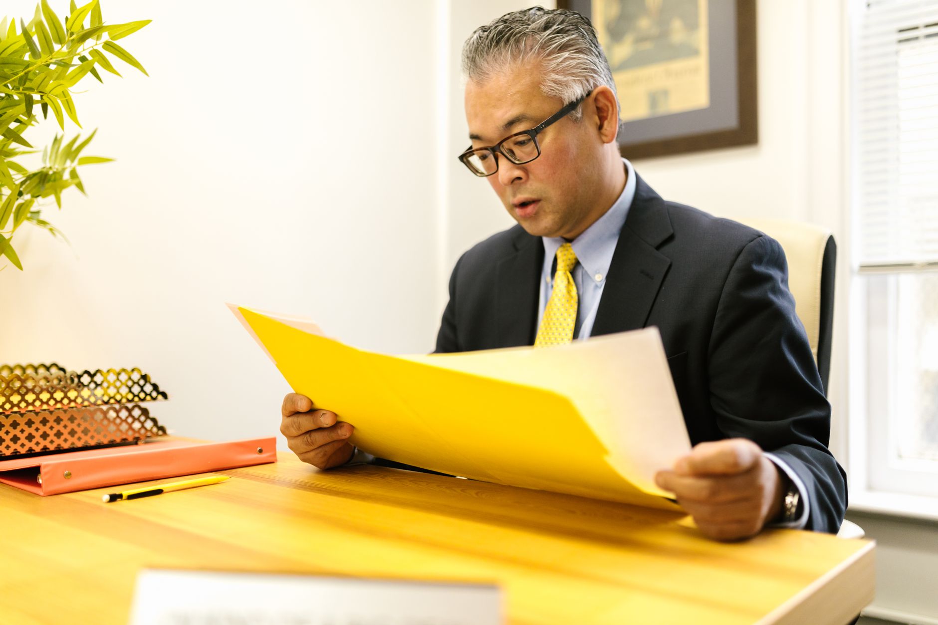 a man looking at files at an office
